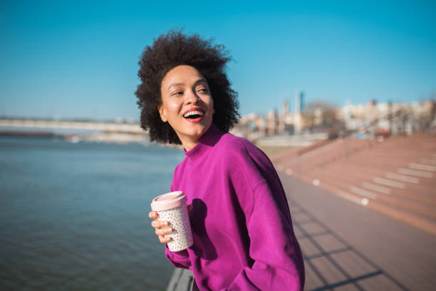 istock Young girl holding a coffee cup 1202113896