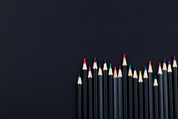 istock line of colored pencils on black background. top view close up flat lay copy space 1202114927