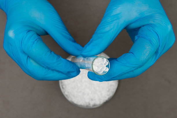 istock Plastic granules . Polyethylene pellets and hands with gloves. Quality control of plastic in the laboratory in production. BPA FREE. 1202115031