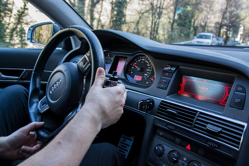 Smolqn, Bulgaria - march 22, 2019 - Man hands holds steering wheel, driving concept, car on the road, audi, transportation concept