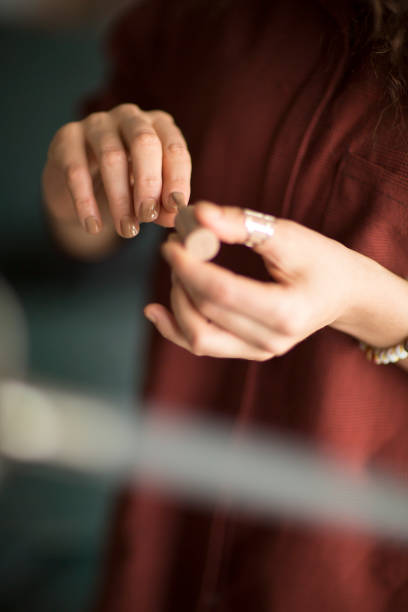 istock Youn woman painting fingernails 1202116451