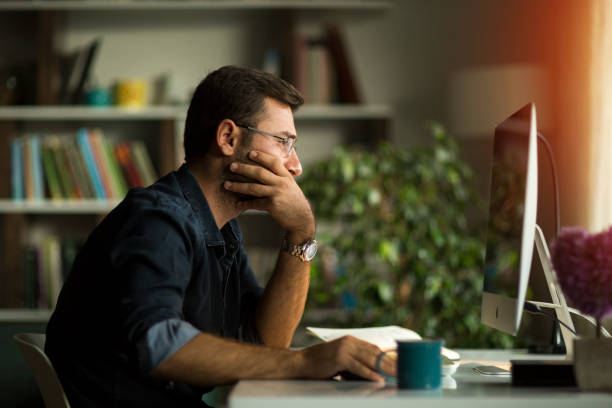 Young man working at home in the evening