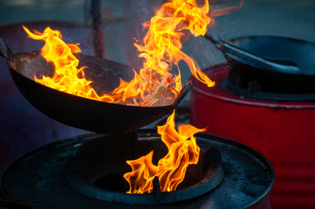 istock Chef cooking with fire in frying pan 1202117587