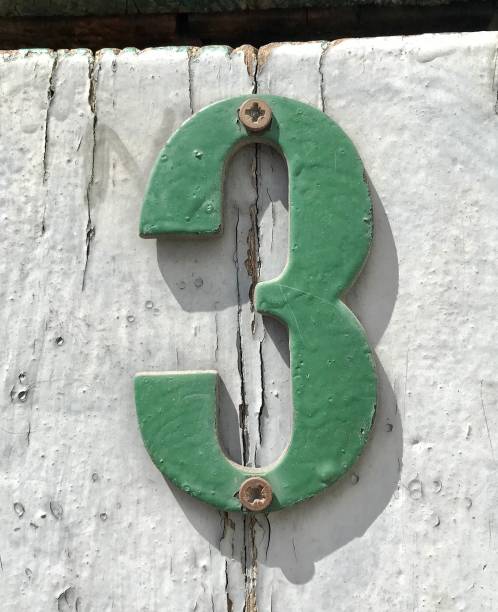 istock Green Number 3, on a White Door 1202117808