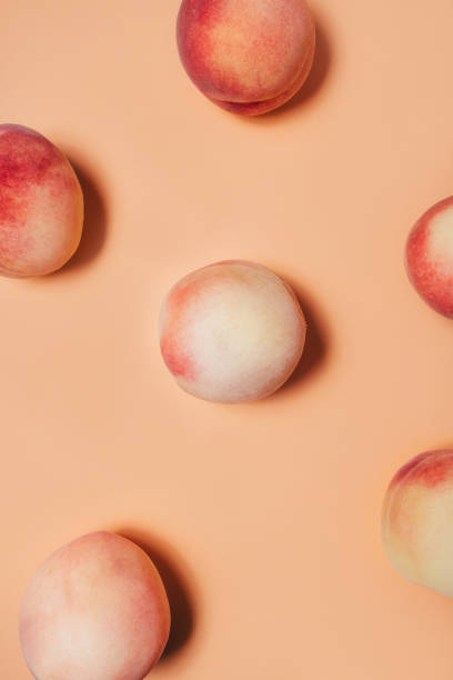 istock A few peaches on a pastel background. 1202121243