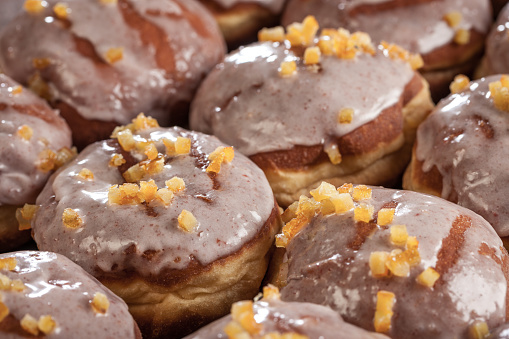 Close up of donuts with sugar icing and orange peel