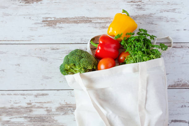 istock Cotton eco-friendly bag for grocery with vegetables. Zero waste, no plastic shopping. Sustainable lifestyle concept. 1202123868