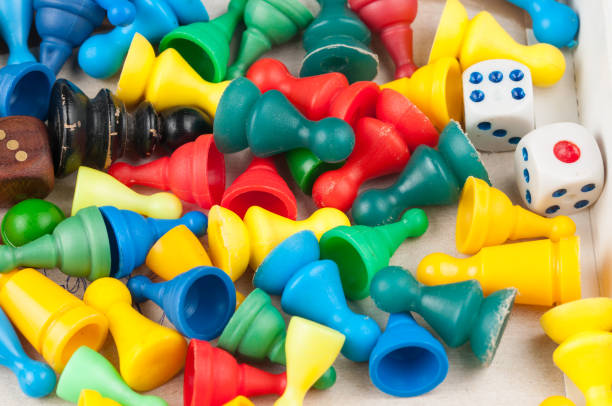 figuras coloridas e dados do jogo de tabuleiro da família ludo - leisure games dice indoors table - fotografias e filmes do acervo