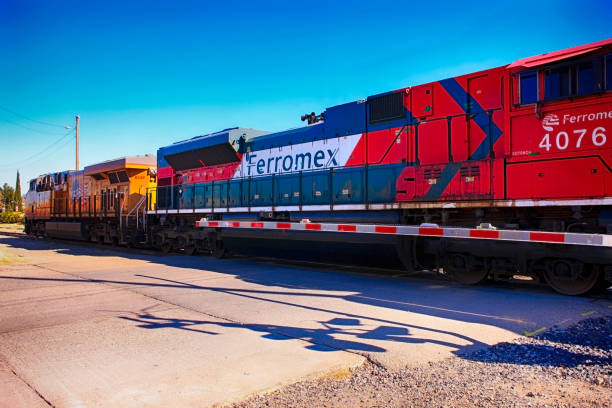 Amtrak and Ferromex diesel locomotives hauling Mexican made vehicles across the border in the US at Nogales AZ Amtrak and Ferromex diesel locomotives hauling Mexican made vehicles across the border in the US at Nogales AZ nogales arizona stock pictures, royalty-free photos & images