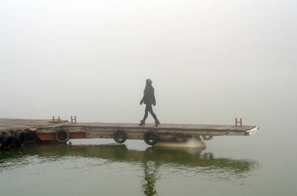 Woman walking on the wooden dock