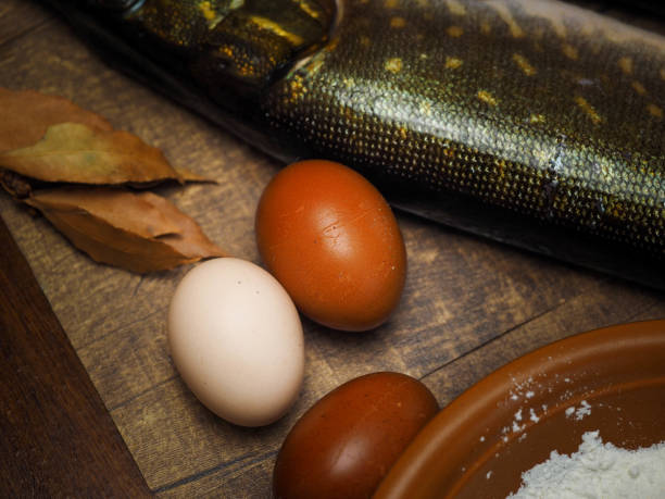 istock Eggs, flour, and fish. Food preparation products 1202124190