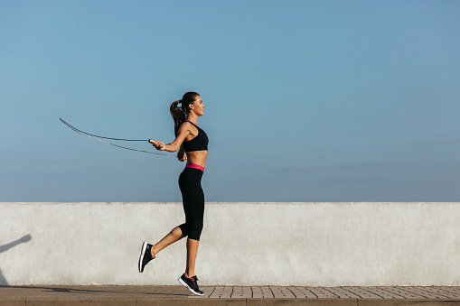 Young woman training with a jumping rope