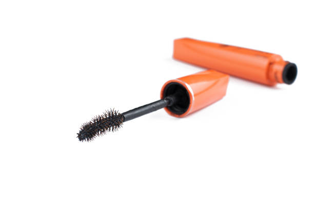 Old orange mascara isolated on white background. Copy space.