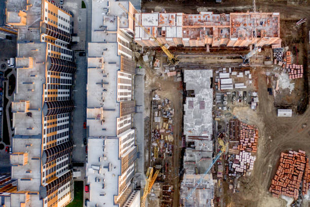 istock Construction and construction of high-rise buildings, the construction industry with working equipment and workers. View from above, from above. Background and texture 1202125173