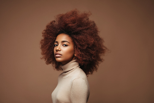 Photo of cheerful curly girl with positive emotions