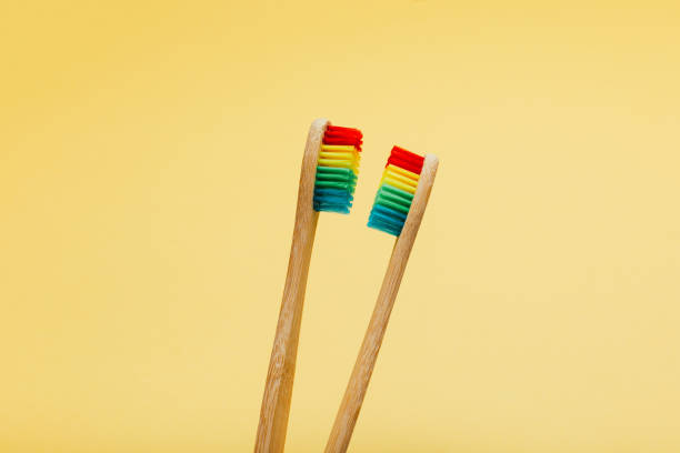 istock Bamboo rainbow dental toothbrush on color background. 1202125488