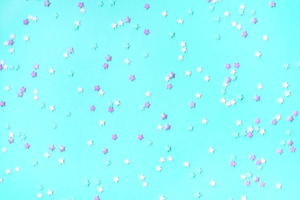 istock Little stars confetti on turquoise background 1202125667
