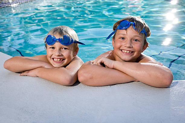 istock Boys grinning on side of swimming pool 120212704