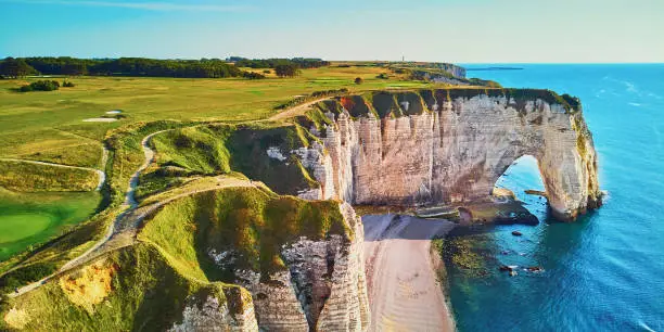 Picturesque panoramic landscape of white chalk cliffs and natural arches of Etretat, Seine-Maritime department of Normandy in France