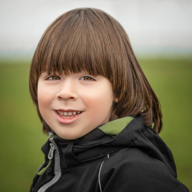 istock Small boy portrait on green background at autumn 1202128316