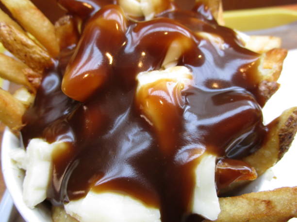 istock Bright Delicious Canadian Poutine Topped with Gravy 1202128398