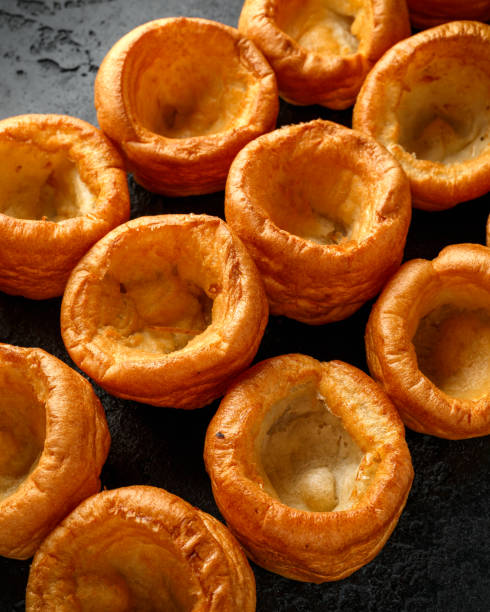 istock Traditional English Yorkshire pudding side dish on black rustic background 1202135028