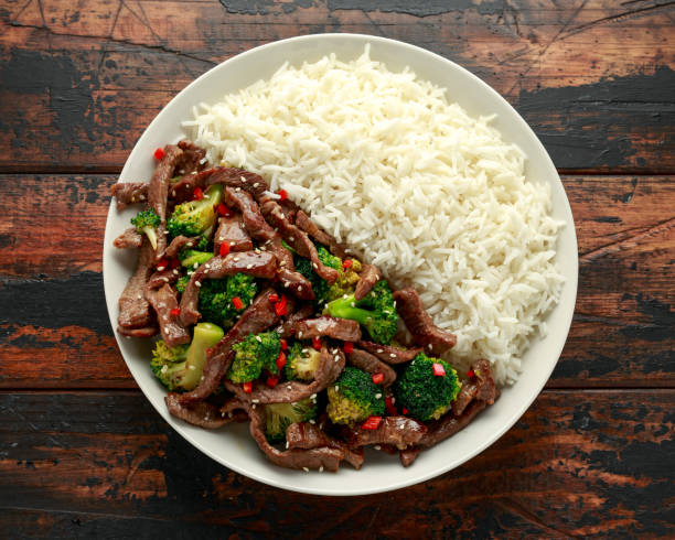 istock Homemade Beef and Broccoli with Rice on wooden table 1202135104