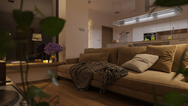 istock Sofa by the Window Inside a Softly Illuminated Open Plan Living Room at Night 1202137190