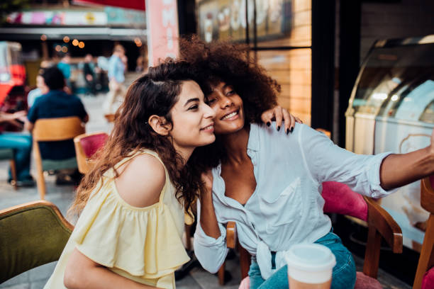 istock Two girlfriends taking a selfie at the cafe 1202138725