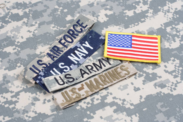 istock US MILITARY concept with branch tapes on camouflage uniform 1202139965