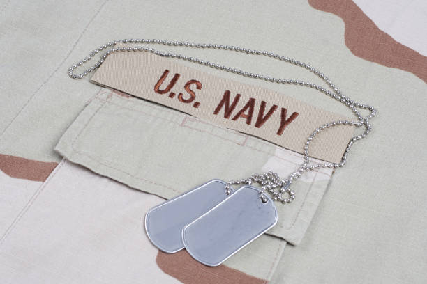 istock US NAVY branch tape with dog tags on desert camouflage uniform 1202140223