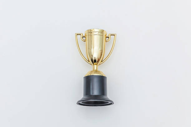 istock Simply flat lay design winner or champion gold trophy cup isolated on white background. Victory first place of competition. Winning or success concept. Top view copy space 1202141372