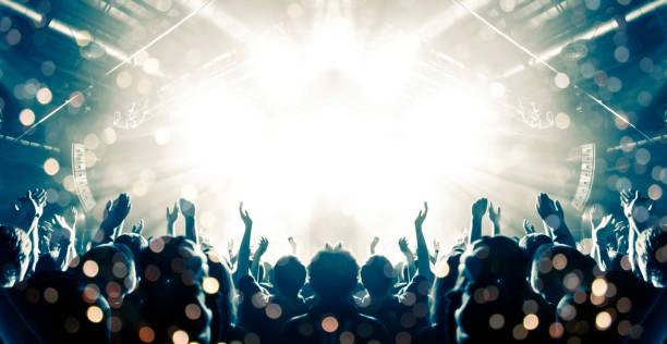 istock Concert hall with people silhouettes 1202142371