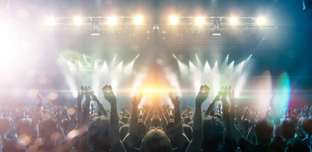 istock Concert hall with people silhouettes 1202142426