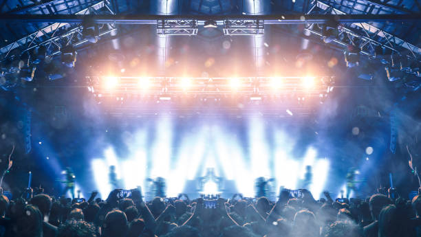 istock Concert hall with people silhouettes 1202142469