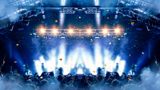 istock Concert hall with people silhouettes 1202142483