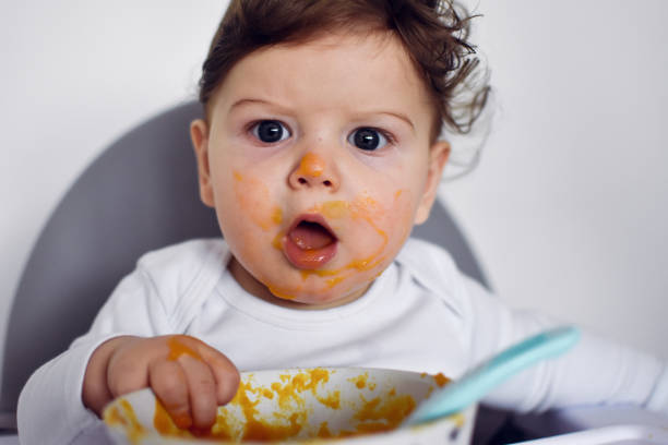 istock A Little baby eating her dinner and making a mess 1202142630