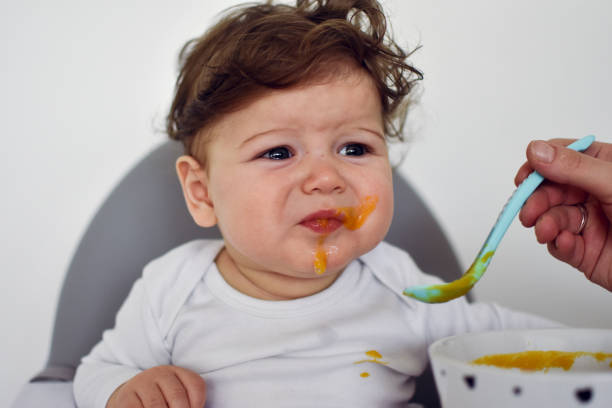 istock A Little baby eating her dinner and making a mess 1202142688