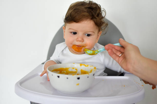 istock A Little baby eating her dinner and making a mess 1202143659