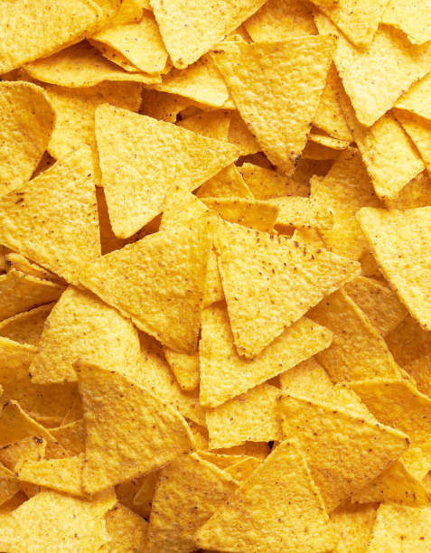 Background of Mexican nachos chips Background of Mexican nachos chips, close up tortilla chip photos stock pictures, royalty-free photos & images