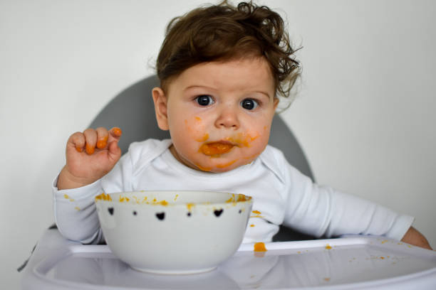 istock A Little baby eating her dinner and making a mess 1202143961