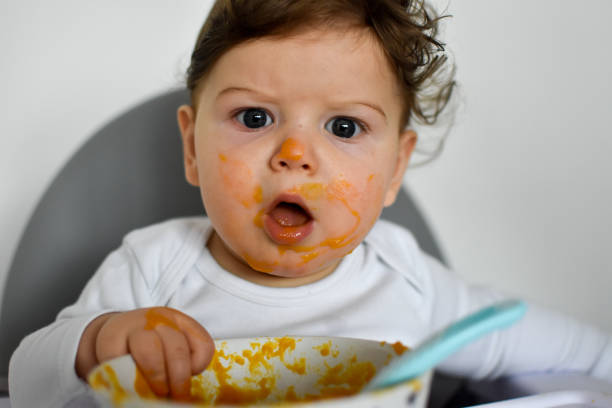 istock A Little baby eating her dinner and making a mess 1202144674