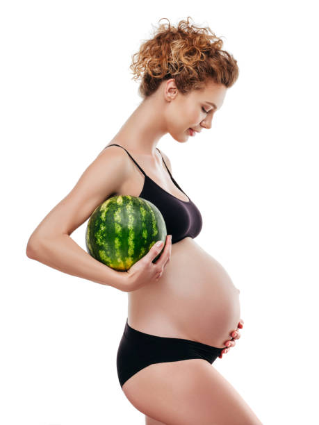 istock Pregnant woman holding a watermelon 1202144767