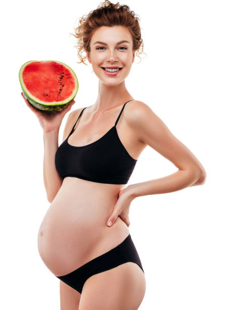 istock Pregnant woman holding a watermelon 1202144807
