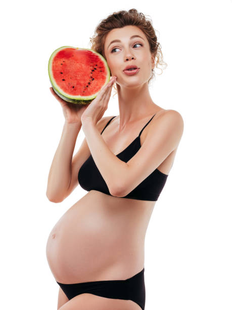 istock Pregnant woman holding a watermelon 1202144856