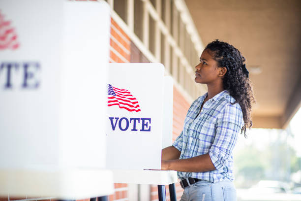 A young black girl voting on election day