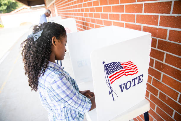 istock Beautiful Young Black Girl Voting 1202146619