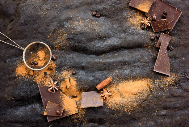 istock Assorted  Chocolate Candies, cacao powder, anise. Chocolate Sweets. Candy Design over dark brown Background. Various Chocolates. Confectionery 1202149878