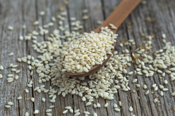 istock Sesame seeds in a wooden background 1202149892