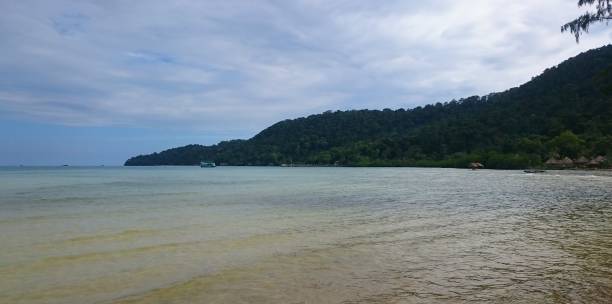 istock Koh rong samloem blue beach and a green hill 1202153732